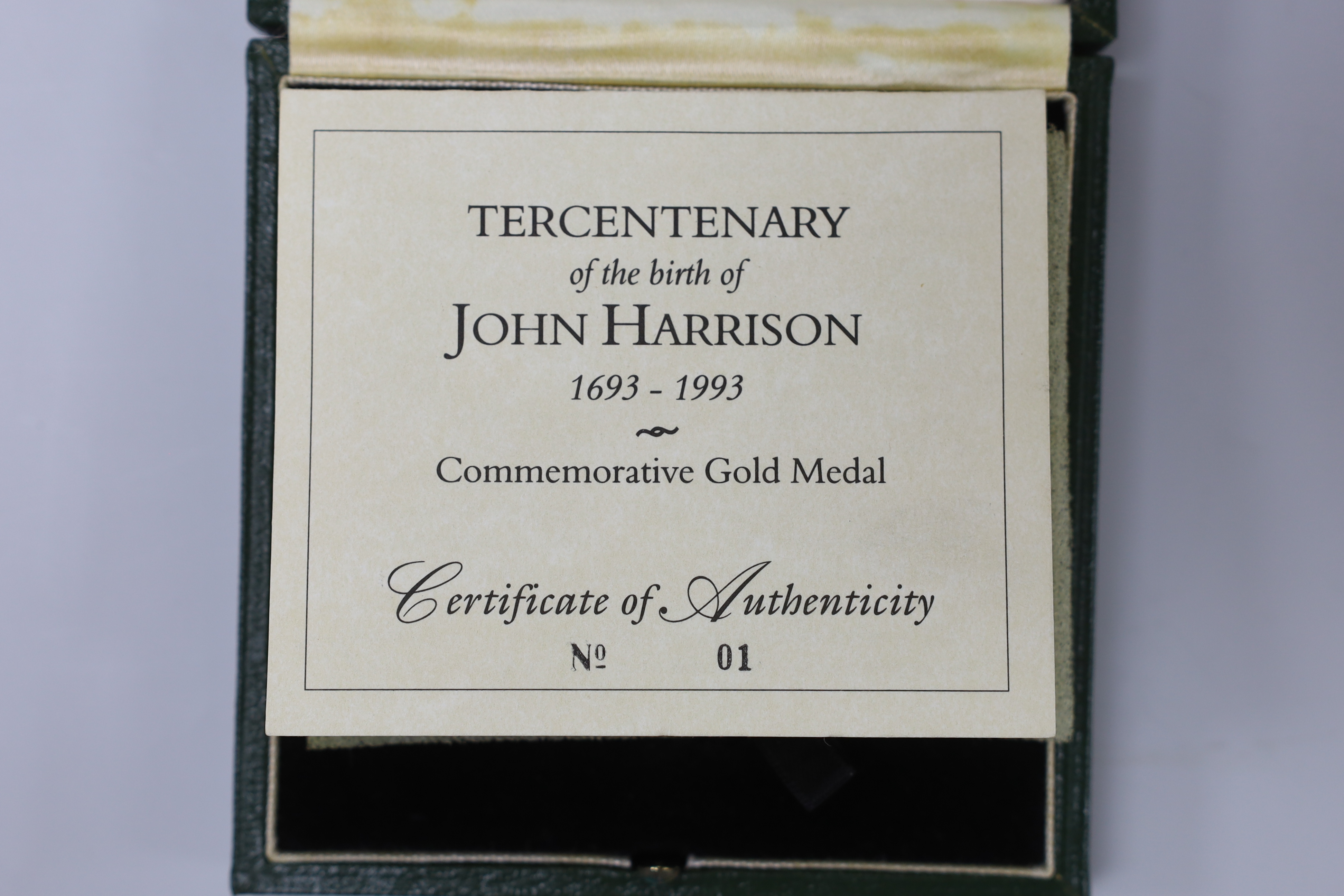 A cased Royal Mint 9ct gold limited edition commemorative gold medal 'Tercentenary of the Birth of John Harrison, 1693-1993', with certificate and paperwork